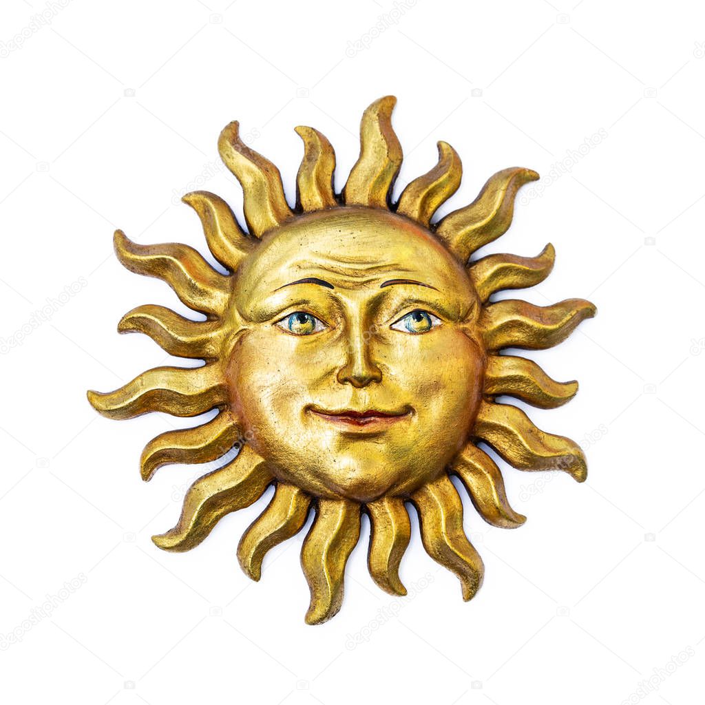 Golden sun face symbol with sunrays isolated on white. Wooden decor ornament symbol painted on gold paint. Summer weather and heat sign.