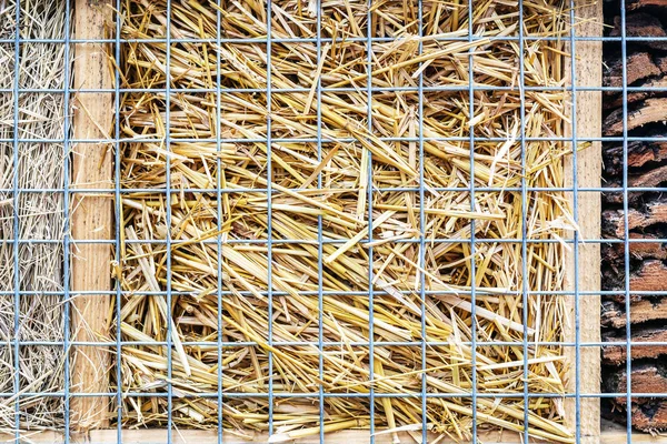 Närbild del av craft hotel eller hus för vilda bin och andra insekter gjord av naturliga ekosystem material. Shelter gjorda av kottar, trä och bambu pinnar, hö, halm och bark — Stockfoto