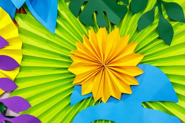Colorful tropical paper flower background. multicolored Flowers and leaves made of paper.