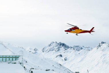 Helikopter yamaçlarında kayak merkezi Alp Dağları'nda, iniş kurtarma. Acil kaza Servisi.