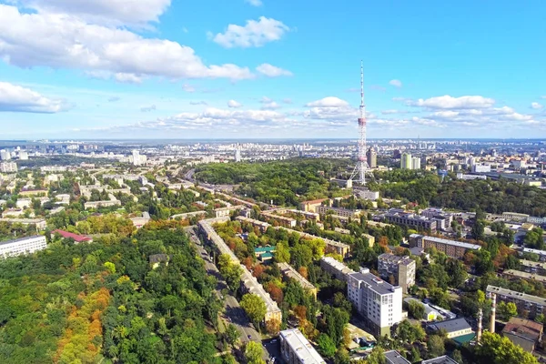 Aerial view of Kiev city streets with park and high steel TV tower against blue sky om bright sunny day — Stock Photo, Image