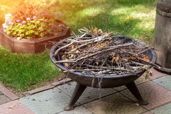 Bärbar järn spis med torr småskog på bakgården av sommarstuga. Bonfire förberedd för kvällen lägerelden berättelser — Stockfoto