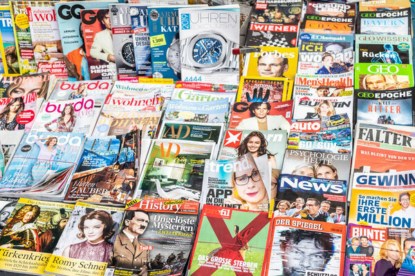 Vienna, Austria - January 15th,2019: Colorful magazine rack on Vienna street. Printed media daily press on different languages on sale at store
