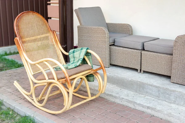 Leere hölzerne Rattan Schaukelstuhl mit grünem Flanell kariert auf der Hausterrasse Hinterhof im Freien. friedlicher Lebensstil zu Hause außen — Stockfoto