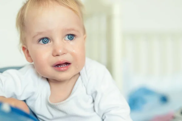 Cute caucasian blond toddler boy portrait crying at home during hysterics. Little child feeling sad. Small pensive baby after quarell — Stock Photo, Image