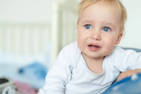 Cute caucasian blond toddler boy portrait crying at home during hysterics. Little child feeling sad. Small pensive baby after quarell — Stock Photo, Image