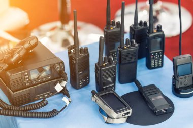 Birçok taşınabilir radyo alıcı-vericileri teknoloji fuarında masada. Farklı walkie-talkie radyo seti. Askeri ve sivil kullanım için iletişim cihazları seçimi