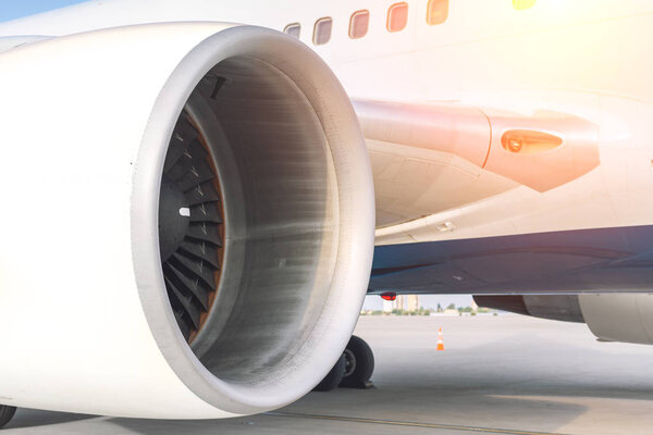 Close-up big commercial plane engine standing on airfiled after aircraft arrival on bright sunny day