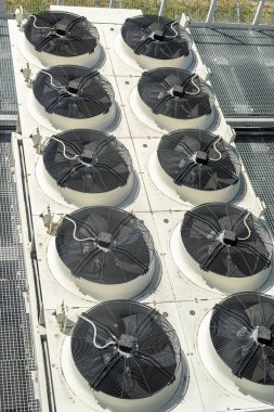 Heavy heating ventilation cooling and air conditioning set system on roof top of big industrial building clipart