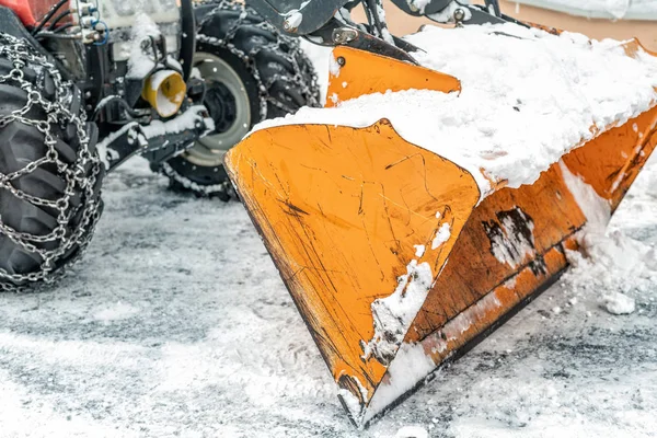 Közeli Snowplow a nagy traktor gép eltávolítása és tisztítása hó után vihar jeges úton vagy a városi utcán az alpesi hegyi üdülőtérségben télen — Stock Fotó