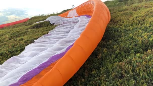 一只滑翔伞从山上的斜坡上飞过 天空上乌云密布 — 图库视频影像