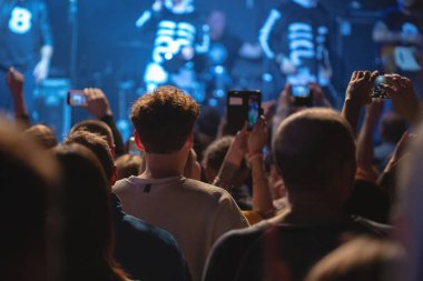 Konser kalabalık kollarını kaldırdı, akıllı insan siluetleri.