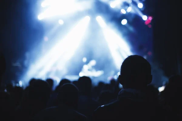 Silhouetten eines Konzertpublikums vor einer beleuchteten Bühne in einem Nachtclub. — Stockfoto