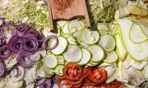 Chopped vegetables. Vegetable grater