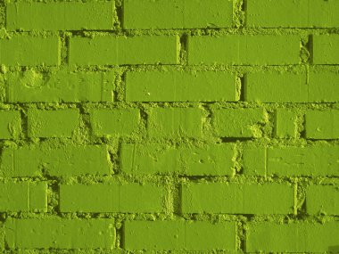 Parlak sarı-yeşil tuğla duvar.