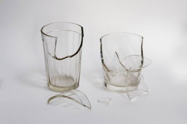 Beyaz arka planda su için iki kırık bardak. Su için kırık cam..