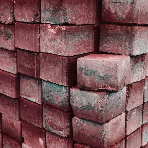 Used red concrete tiles for sidewalks.Packed old red bricks for storage.
