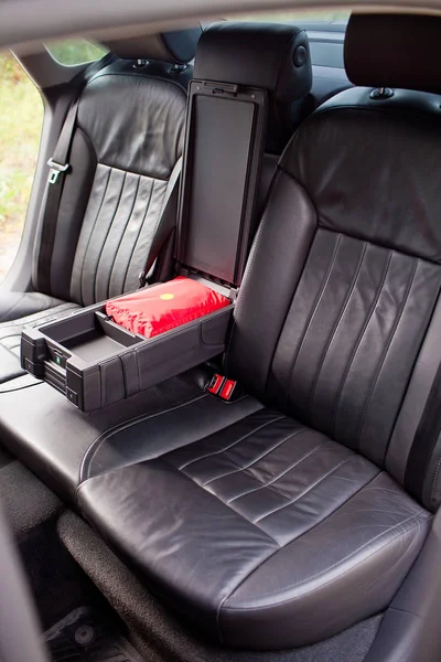 Rear leather seats with armrest in luxury car.