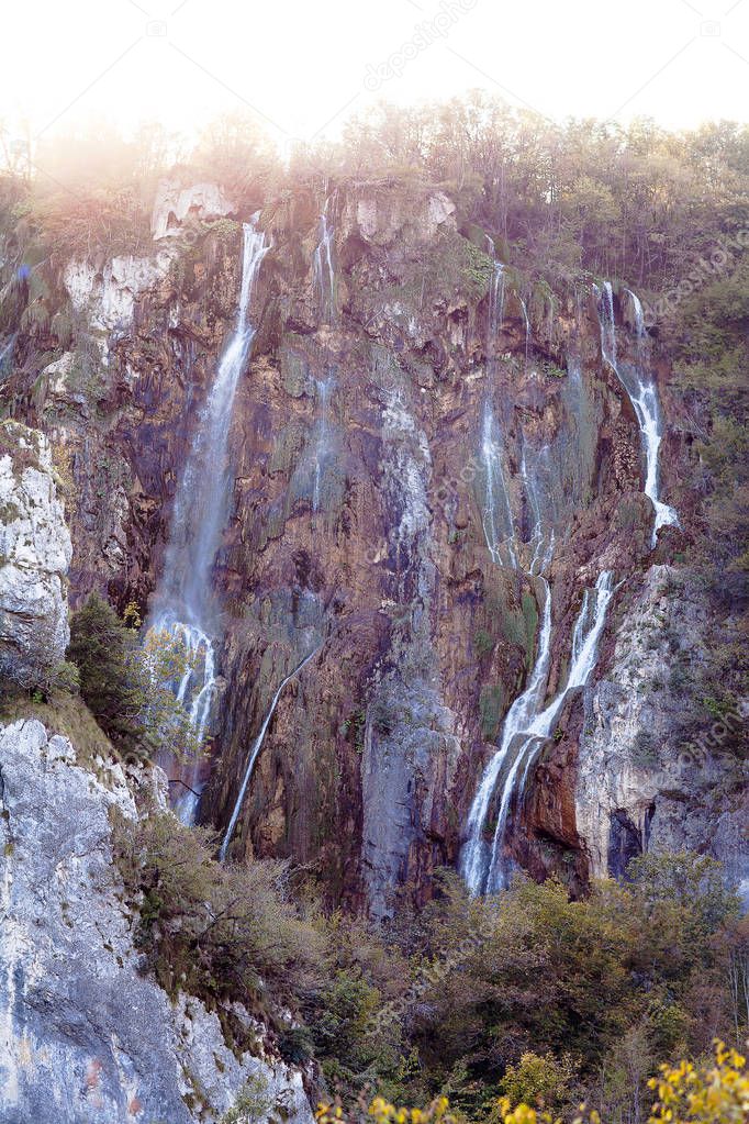 Water that falls from a large waterfall over stone slopes, Plitvice Lakes