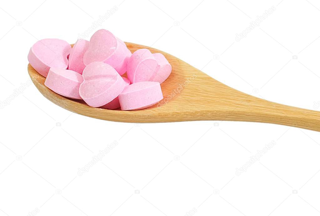Healthcare Concept, Close Up Wooden Spoon Full with Pink Heart Shape of Vitamins Pill Isolated on A White Background.