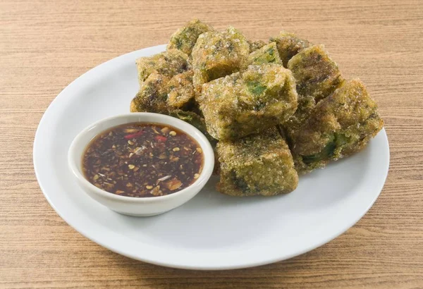 Plate of Fried Chinese Pancake or Fried Steamed Dumpling Made of Garlic Chives, Rice Flour and Tapioca Flour Served with Spicy Soy Sauce. Traditional Food of China.