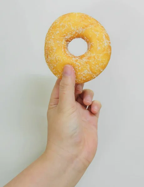 Alimentos Panadería Mano Sosteniendo Deliciosa Rosquilla Fresca Dulce Con Coberturas — Foto de Stock