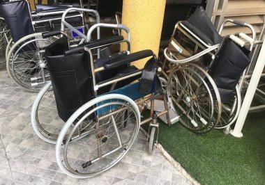 Empty Wheelchairs or Chair with Wheels Use By People Who Cannot Walk for Moving Around, Preparing to Use in Hospital. clipart