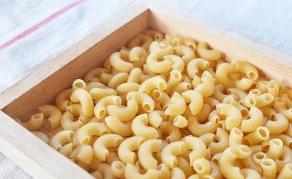 Dried Elbow Macaroni in A Wooden Tray — Stock Photo, Image