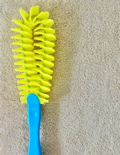 Close Yellow Plastic Cleaning Brush Blue Handle Laying Brown Towel — Stock Photo, Image