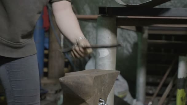 Primer plano de la herrería mujer martillando una barra de metal para enderezarlo en su taller de bricolaje utilizando diferentes martillos — Vídeo de stock