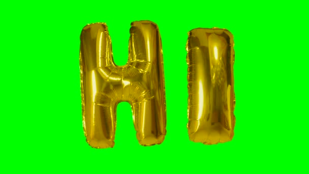 Word hi from helium gold balloon letters floating on green screen — Stock Video