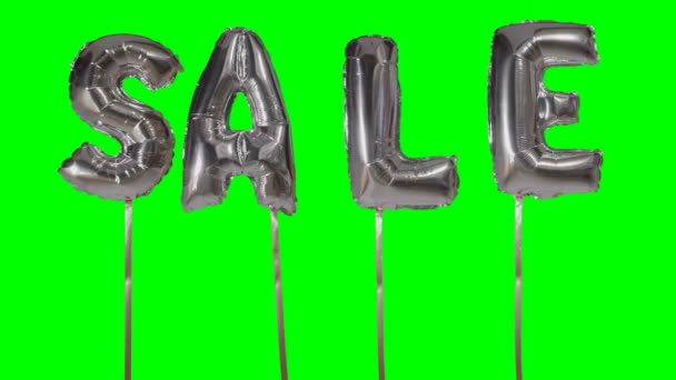 Word sale from helium silver balloon letters floating on green screen — Stock Video