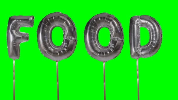 Word voedsel uit zilveren helium ballon brieven drijvend op groen scherm — Stockvideo