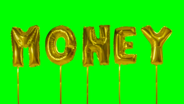 Word geld uit gouden helium ballon brieven drijvend op groen scherm — Stockvideo