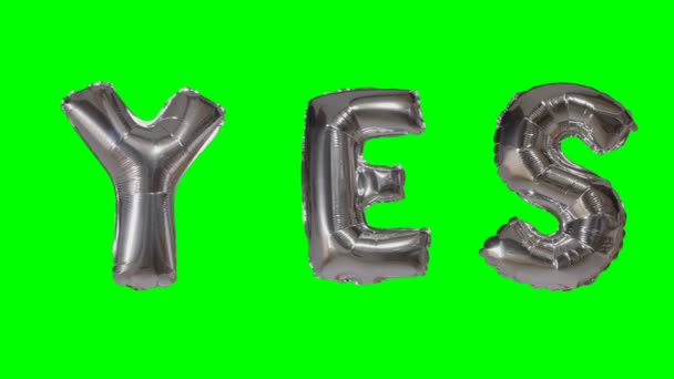 Word yes from helium silver balloon letters floating on green screen — Stock Video