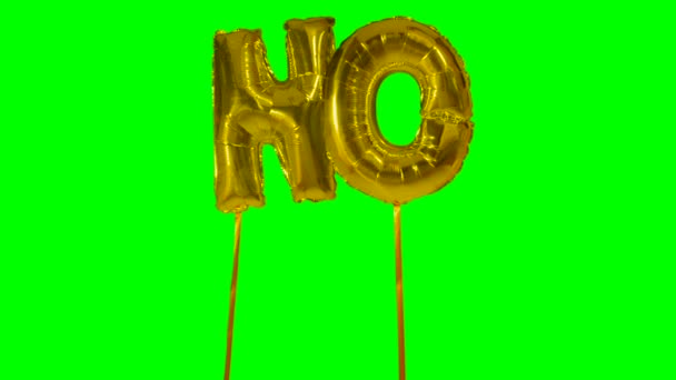 Слово "нет" от золотых букв гелия, плавающих на зеленом экране — стоковое видео