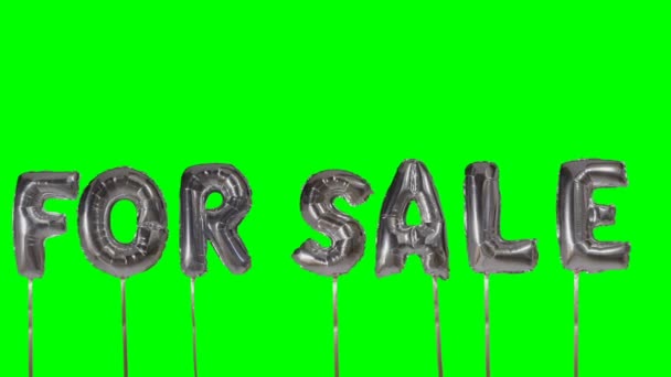 Word for sale from helium silver balloon letters floating on green screen — Stock Video