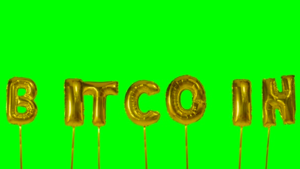 Слово Bitcoin из золотого гелиевого шара буквы плавающие на зеленом экране — стоковое видео