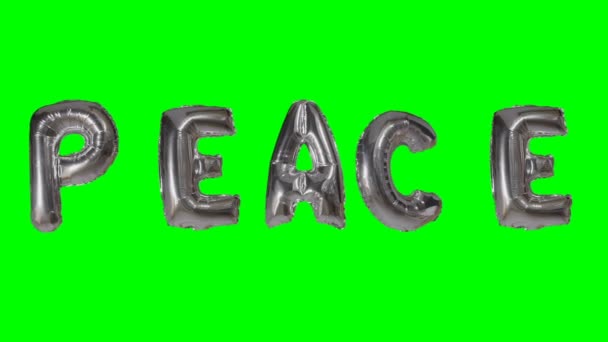 緑色の画面に浮かぶ銀のヘリウム風船文字から単語の平和 — ストック動画
