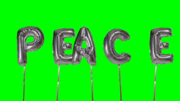 Слово мир из гелиевого серебристого шара буквы плавающие на зеленом экране — стоковое видео