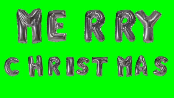Χαρούμενα Χριστούγεννα χαιρετισμό από ήλιο ασημένια γράμματα μπαλόνι επιπλέει στην πράσινη οθόνη του Word — Αρχείο Βίντεο