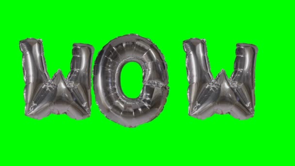 Word wow van zilveren helium ballon brieven drijvend op groen scherm — Stockvideo