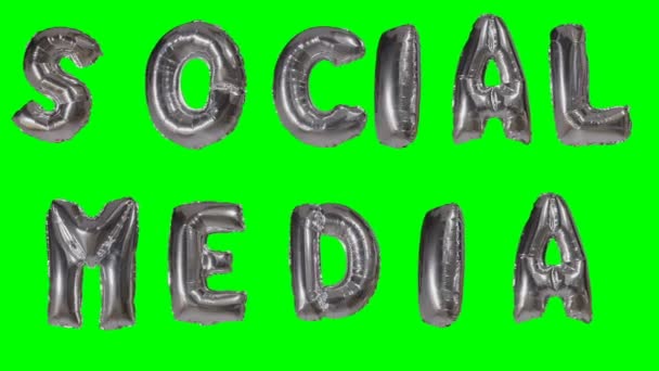 Word social media from helium gold balloon letters floating on green screen — Stock Video