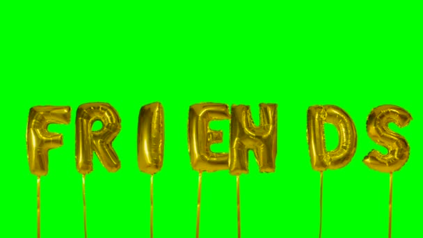 Ordet vänner från helium gyllene ballong bokstäver flyter på grön skärm — Stockvideo
