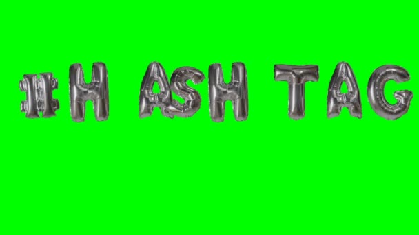 Word hashtag from helium silver balloon letters floating on green screen — Stock Video