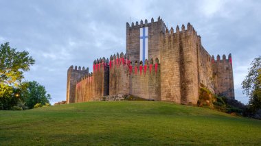 Guimaraes, Portugal - May 31, 2018 : castle decorated with flags Guimaraes, Portugal clipart