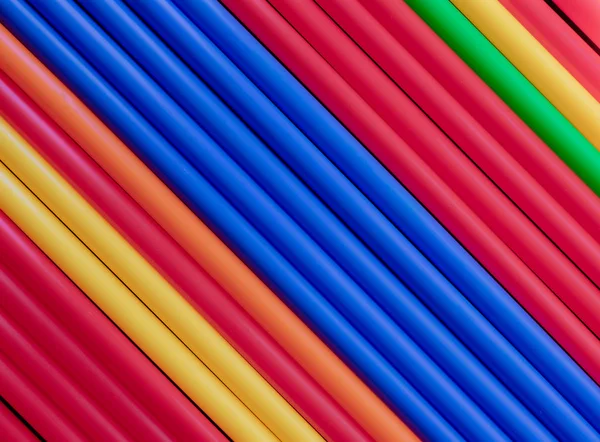 Colorful Plastic Tubes Straws Blue Center Diagonal Background — Stock Photo, Image
