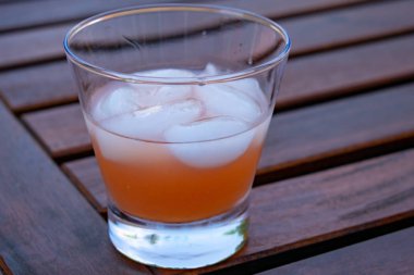 Bulanık arka plan ile ahşap masa üzerinde soğuk içecek bardak 