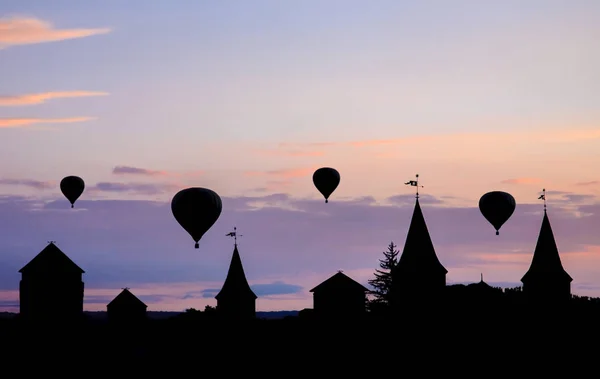 Hot air balloons on sunset. Beautiful nature sky background. Against the backdrop of the castle.
