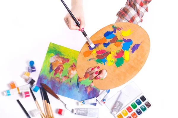 Palette with paints close-up in female hands. Studio shot. — Stock Photo, Image